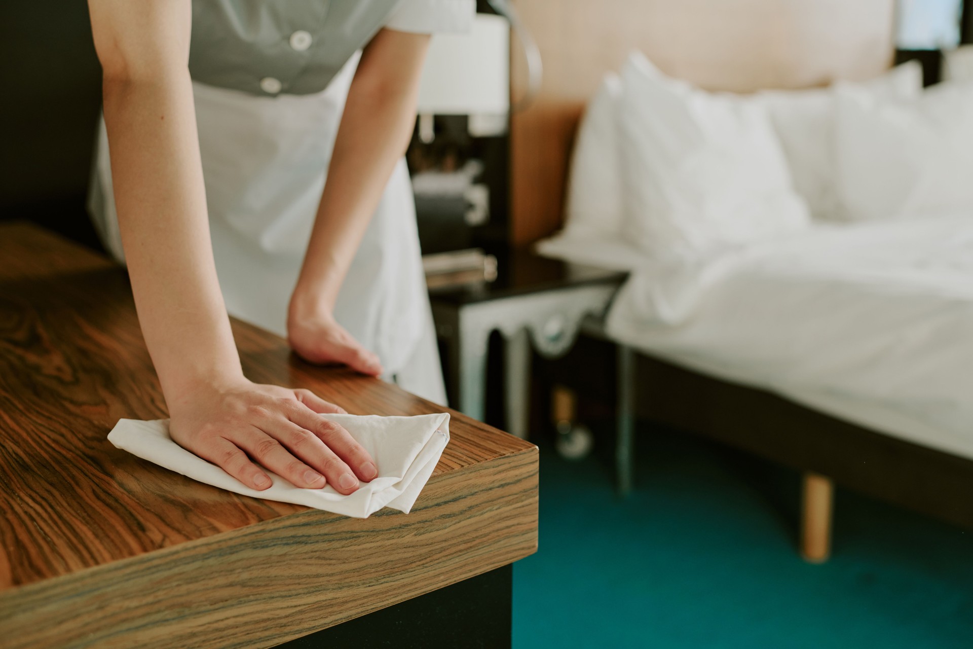 Woman Using Napkin to Clean Table